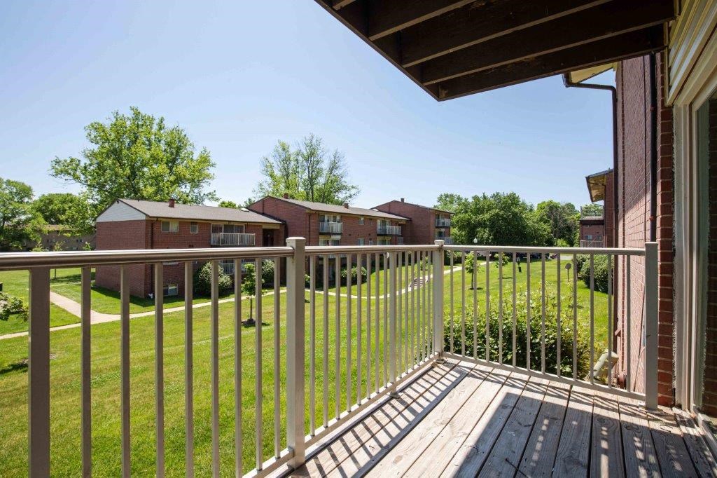 the view of the yard from the balcony of a home with a deck