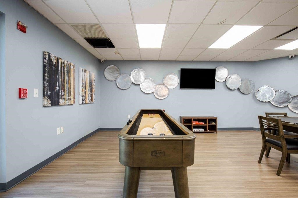 a game room with a foosball table and a wall of plates