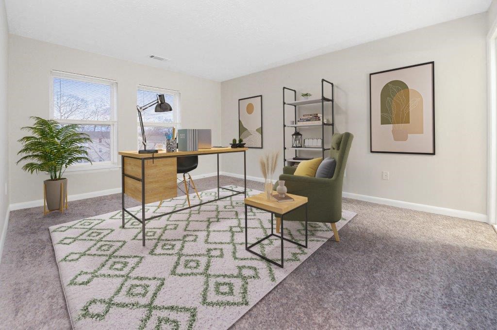 a living room with a couch and a desk