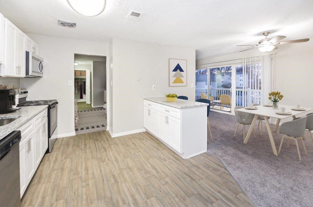 an open kitchen and dining room with a table and chairs