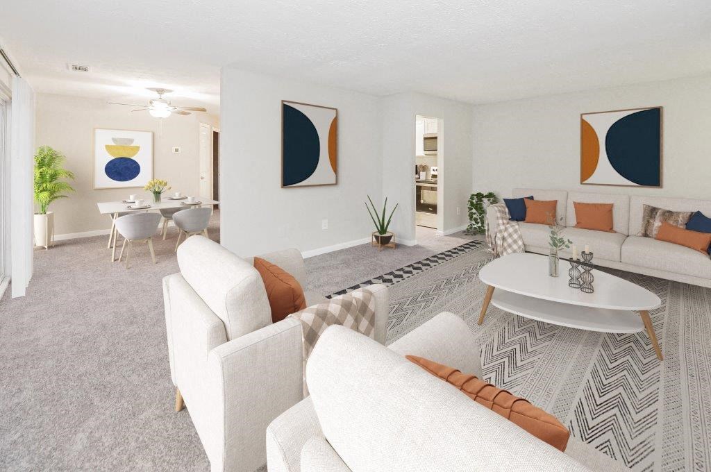 a living room with couches and chairs and a table