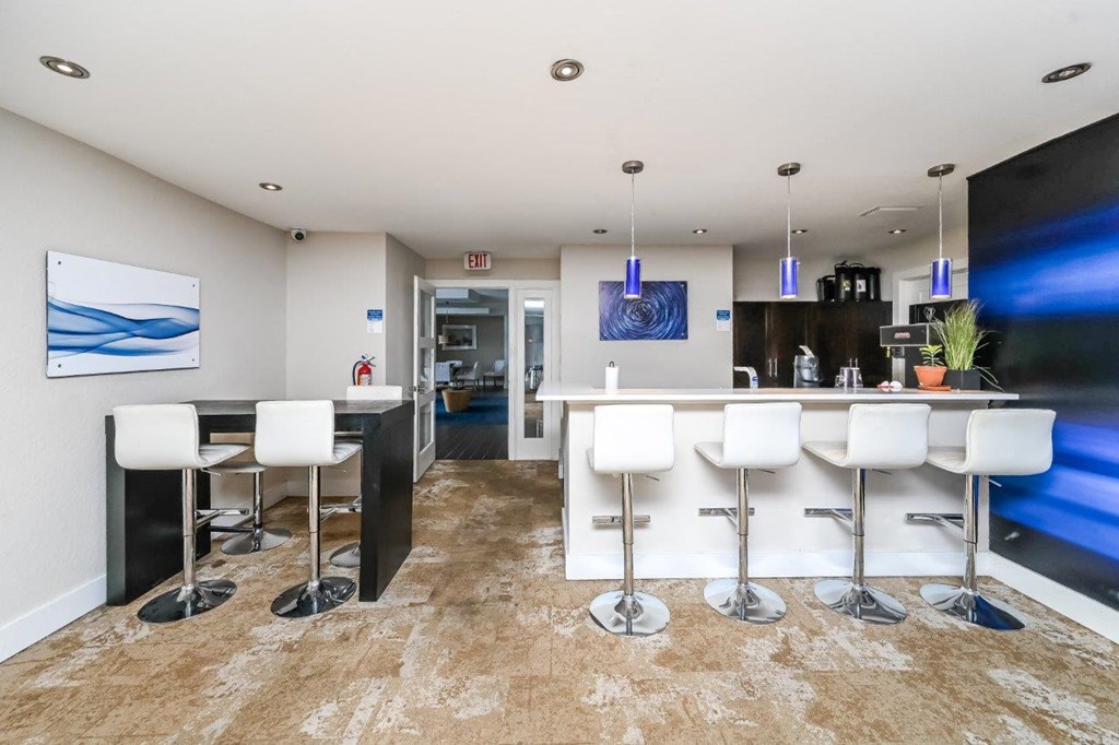 a kitchen and dining room with a bar and stools