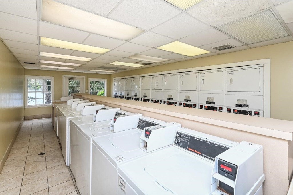 a group of washers and dryers in a laundry room