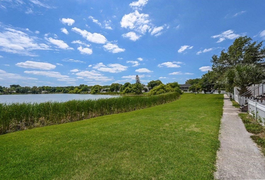 a sidewalk next to a body of water