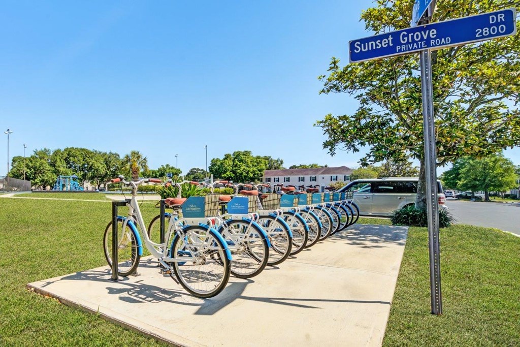 a row of bikes parked on the sidewalk at sunset grove bike park