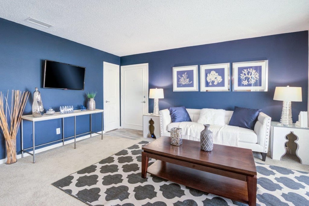 a living room with blue walls and a white couch
