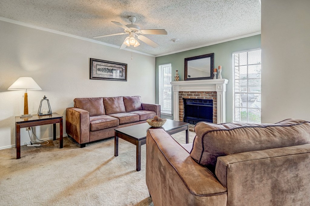 a living room with couches and a fireplace