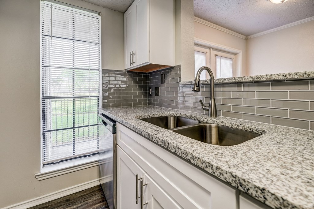 an empty kitchen with a sink and a window