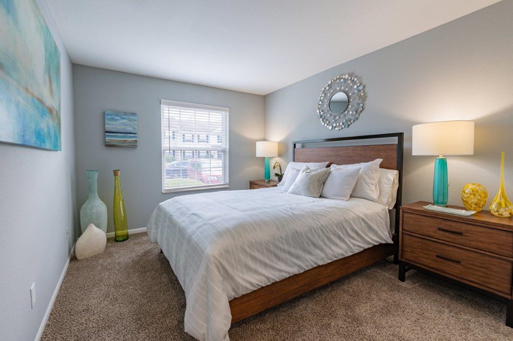 a bedroom with a bed and a window