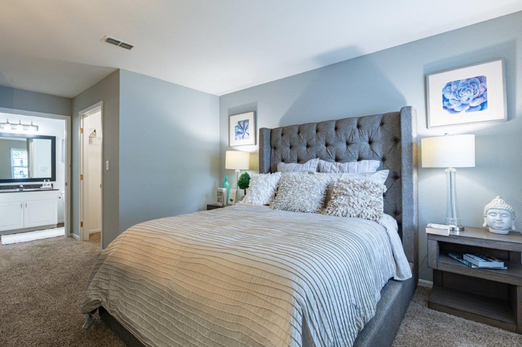 a bedroom with blue walls and a large bed