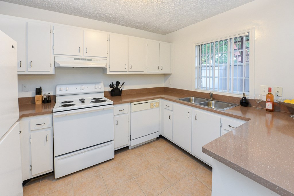 a kitchen with white appliances and white cabinets