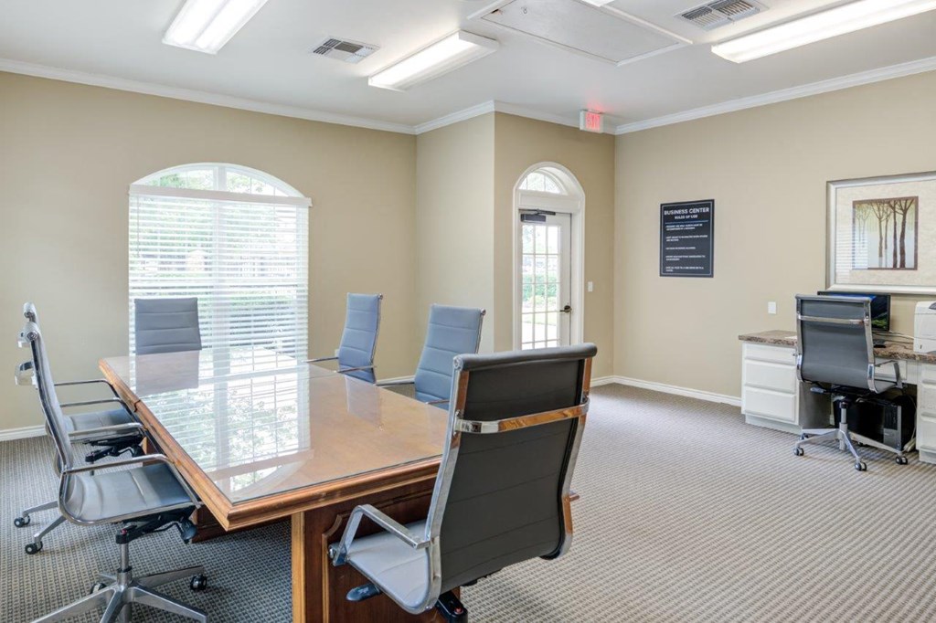 a conference room with a wooden table and chairs