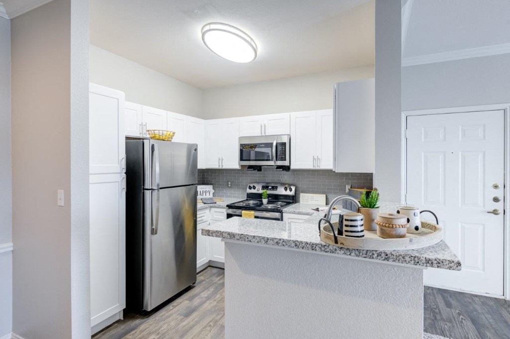 a kitchen with stainless steel appliances and a granite counter top