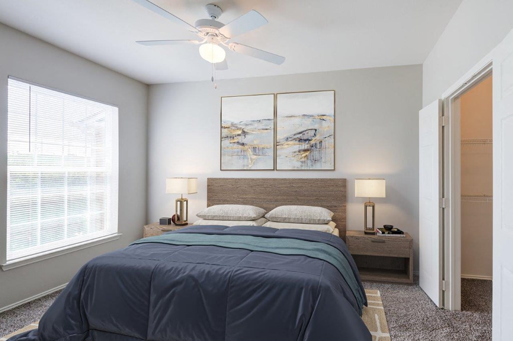 a bedroom with a bed and a ceiling fan