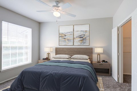 a bedroom with a bed and a ceiling fan
