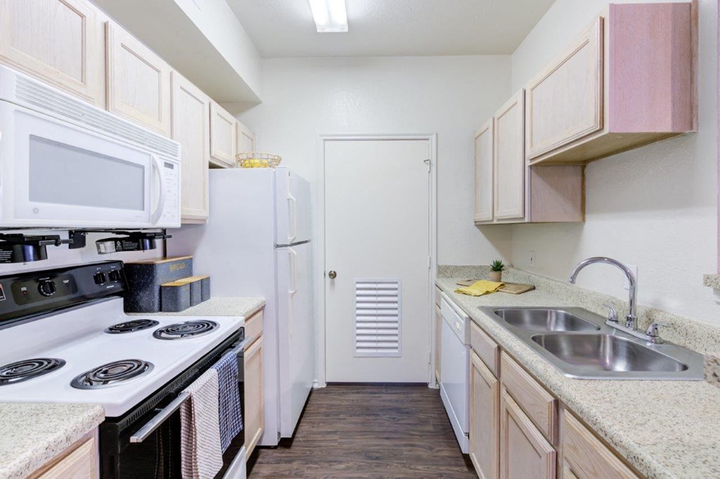 a kitchen with a stove sink and a refrigerator