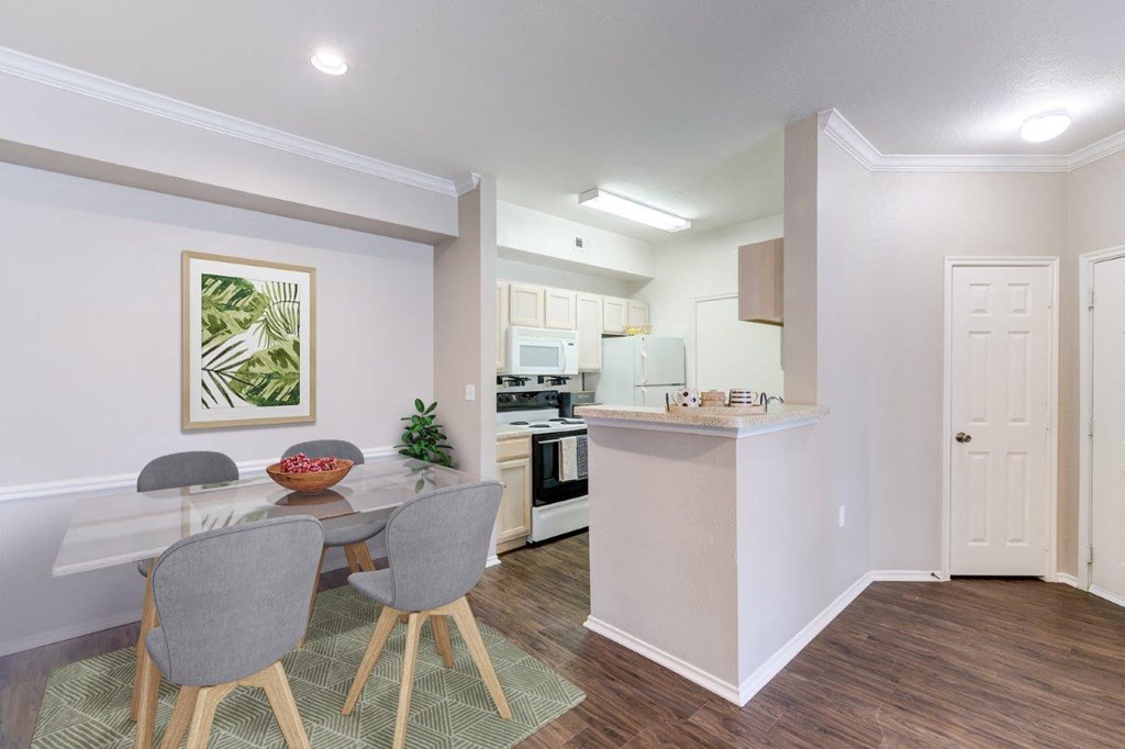 a dining room and kitchen with a table and chairs