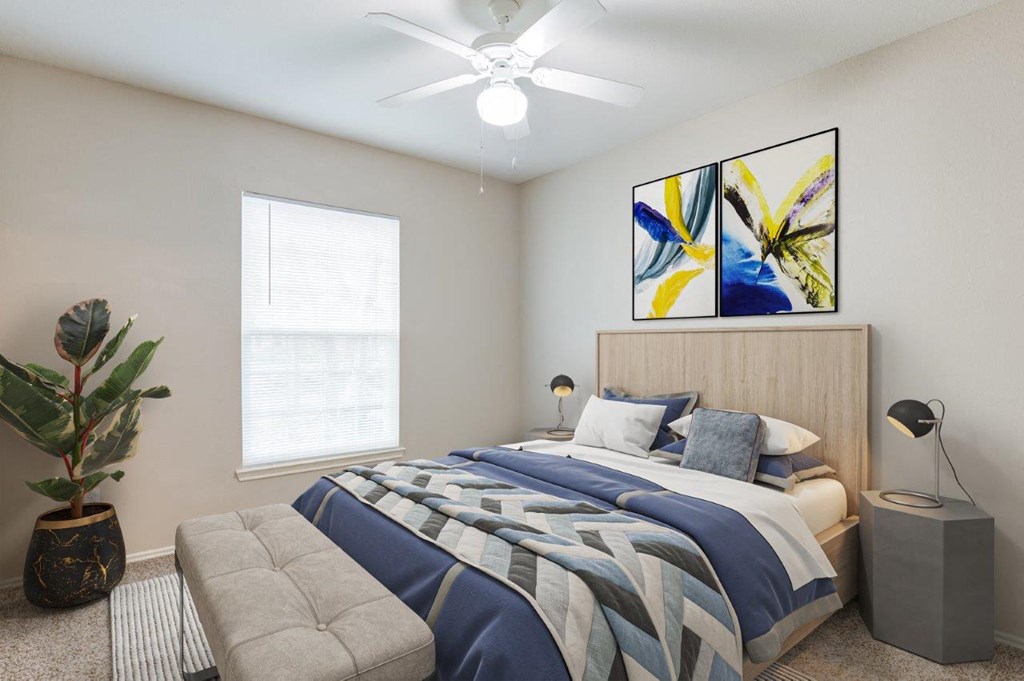 a bedroom with a bed and a ceiling fan