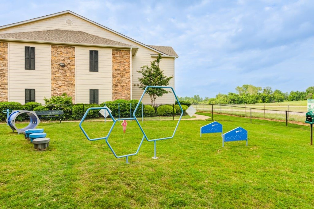 a swing set in a yard in front of a house