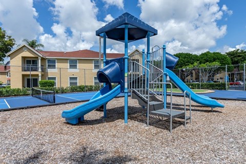 our apartments have a playground with a slide and a basketball court