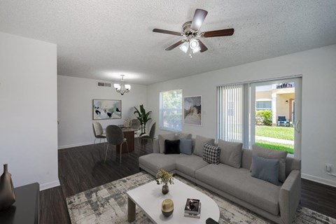 a living room with a couch and a ceiling fan