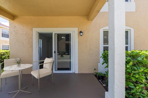 a patio with a chair and a table on it
