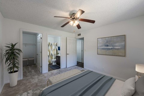 a bedroom with a bed and a ceiling fan