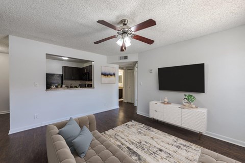 a living room with a couch and a ceiling fan