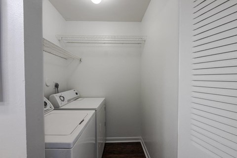 a laundry room with a washer and dryer and white walls