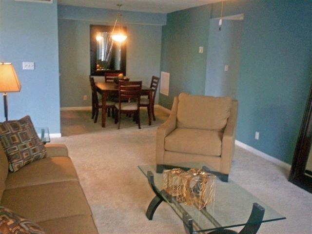 a living room with a couch and a glass table