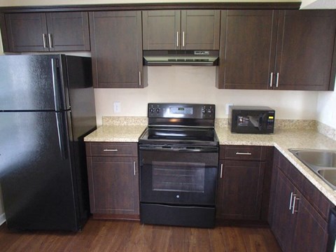 a kitchen with a stove and a refrigerator