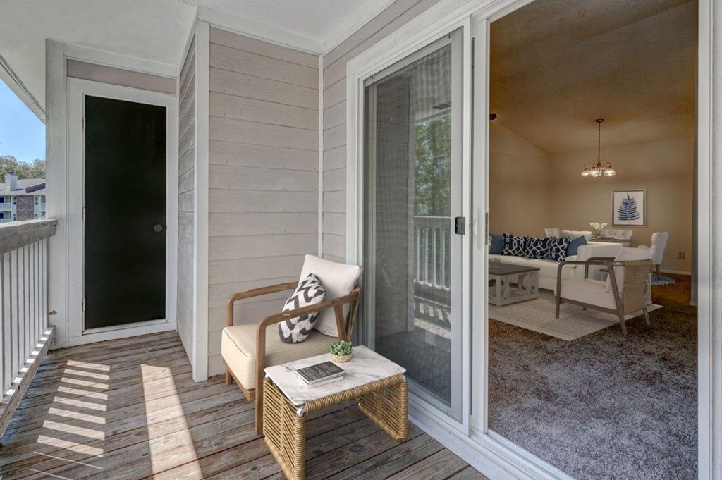 A balcony with a chair and a table.