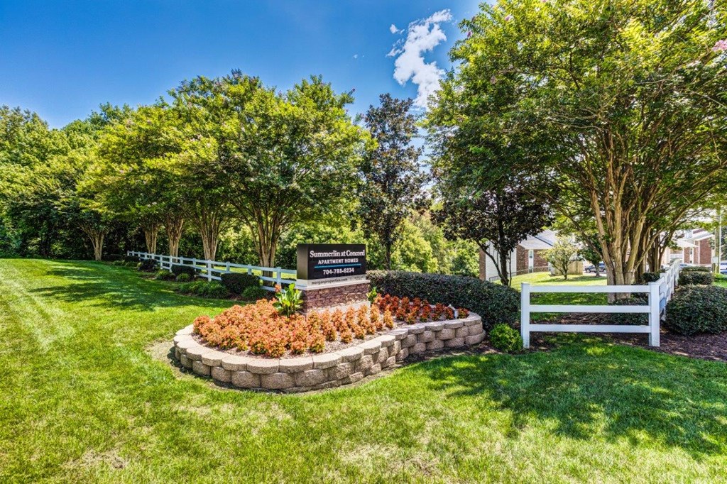 A sign in a garden reads "Sunset Hill".