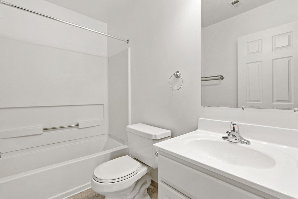 a bathroom with a sink toilet and a bath tub