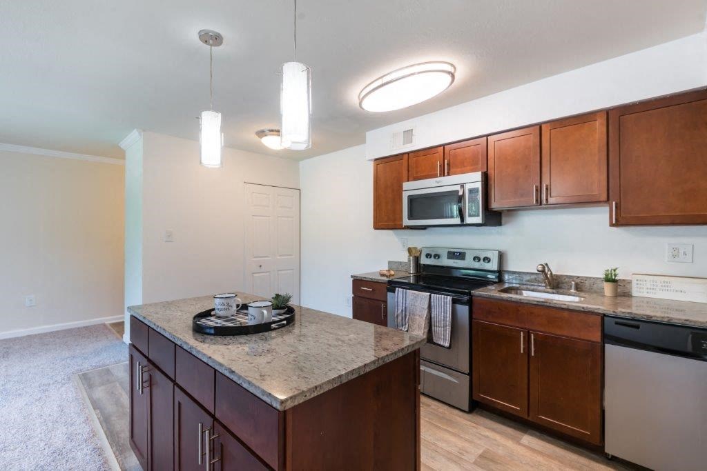 a kitchen with stainless steel appliances and granite counter tops