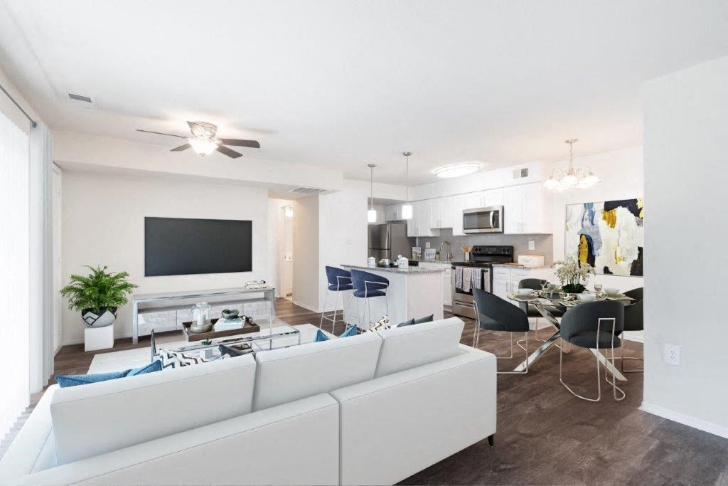 a living room and dining room with white furniture