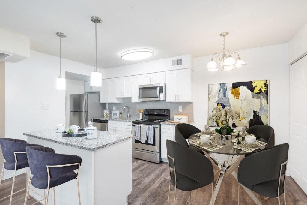 a kitchen and dining room with a table and chairs