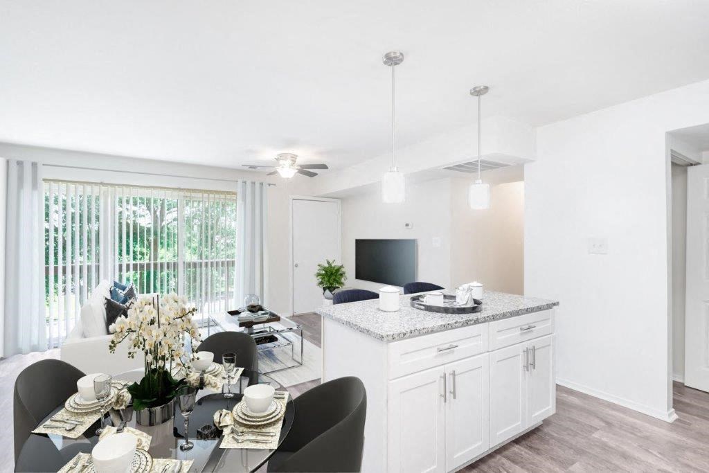 a kitchen and living room with a table and chairs