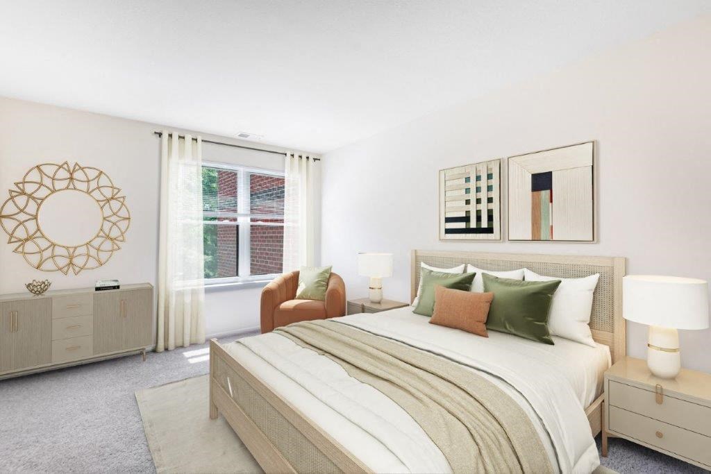 a bedroom with a bed and a chair and a window