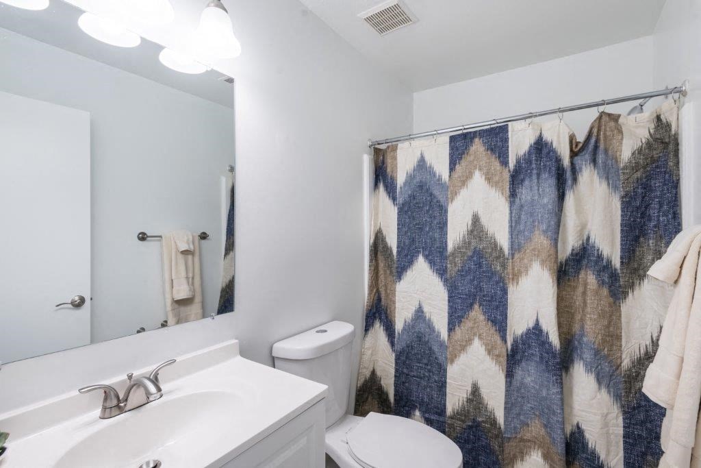 a bathroom with a sink toilet and a shower