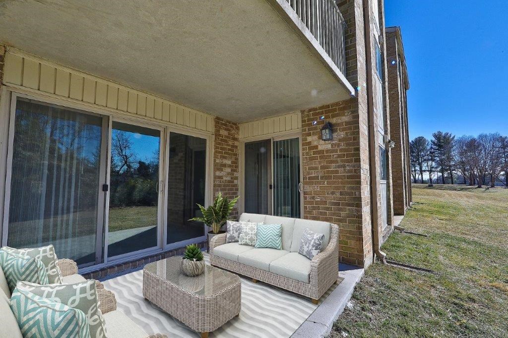 a living room with a couch and chairs on a patio