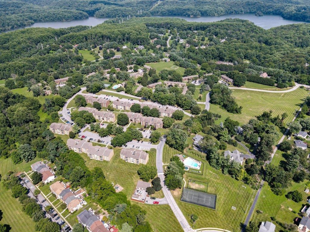 an aerial view of a neighborhood of houses and a body of water