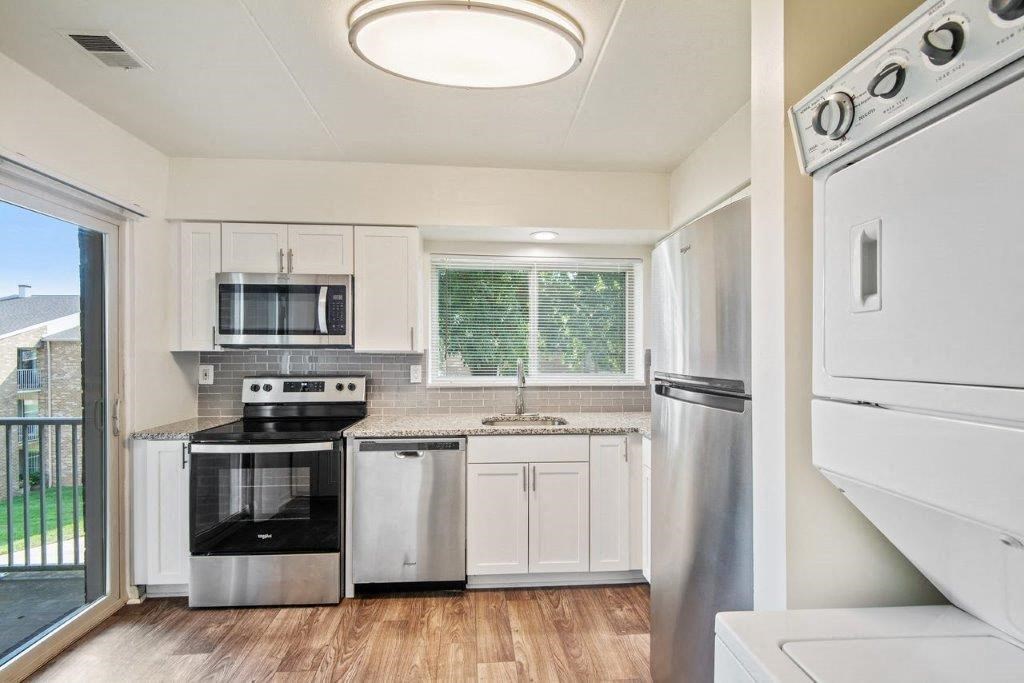 a kitchen with stainless steel appliances and a window