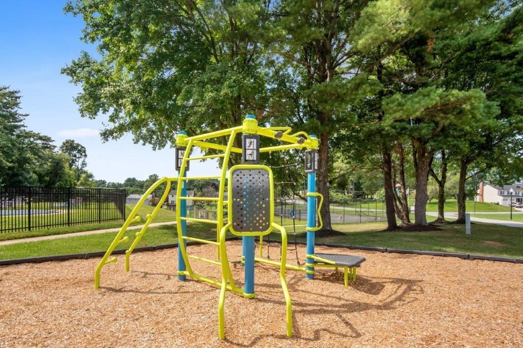 a yellow and blue swing set in a park