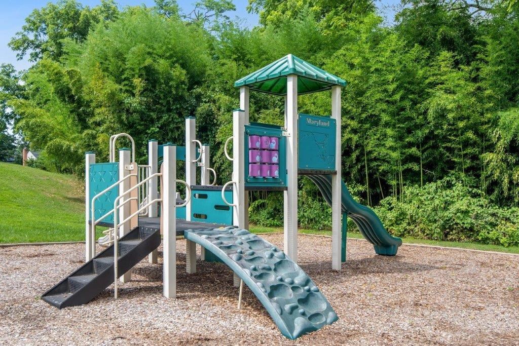 a playground with a slide and a climbing structure