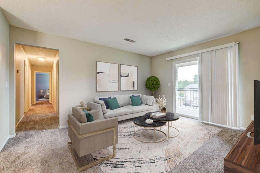 a living room with a couch and a table     and a hallway