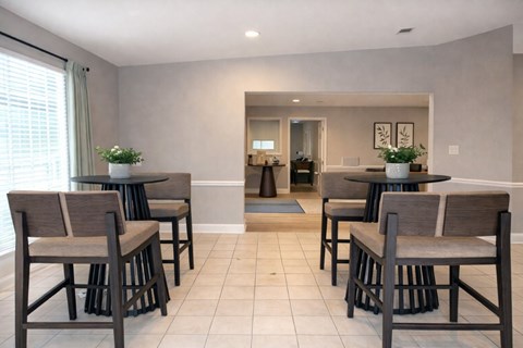 A dining room with a table and chairs.