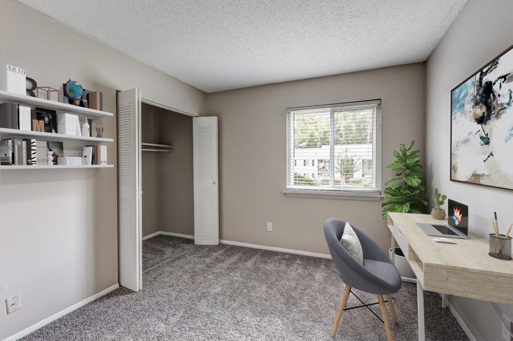 a home office with a desk and a window