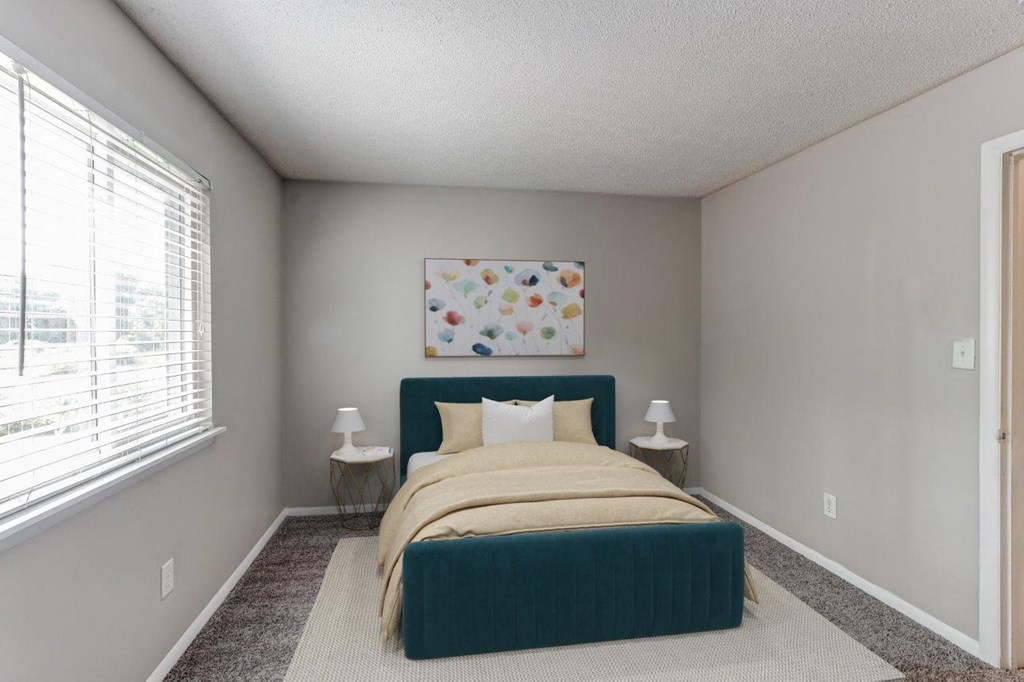 a bedroom with a bed and a large window