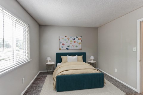 a bedroom with a bed and a large window